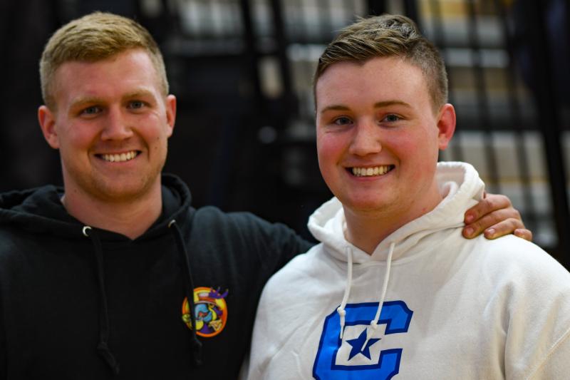 Chris and Jackson Handlin won crucial matches in Cape’s 34-33 victory over Smyrna in 2019. They’re shown in 2024 as alumni watching a match. DAVE FREDERICK PHOTOS